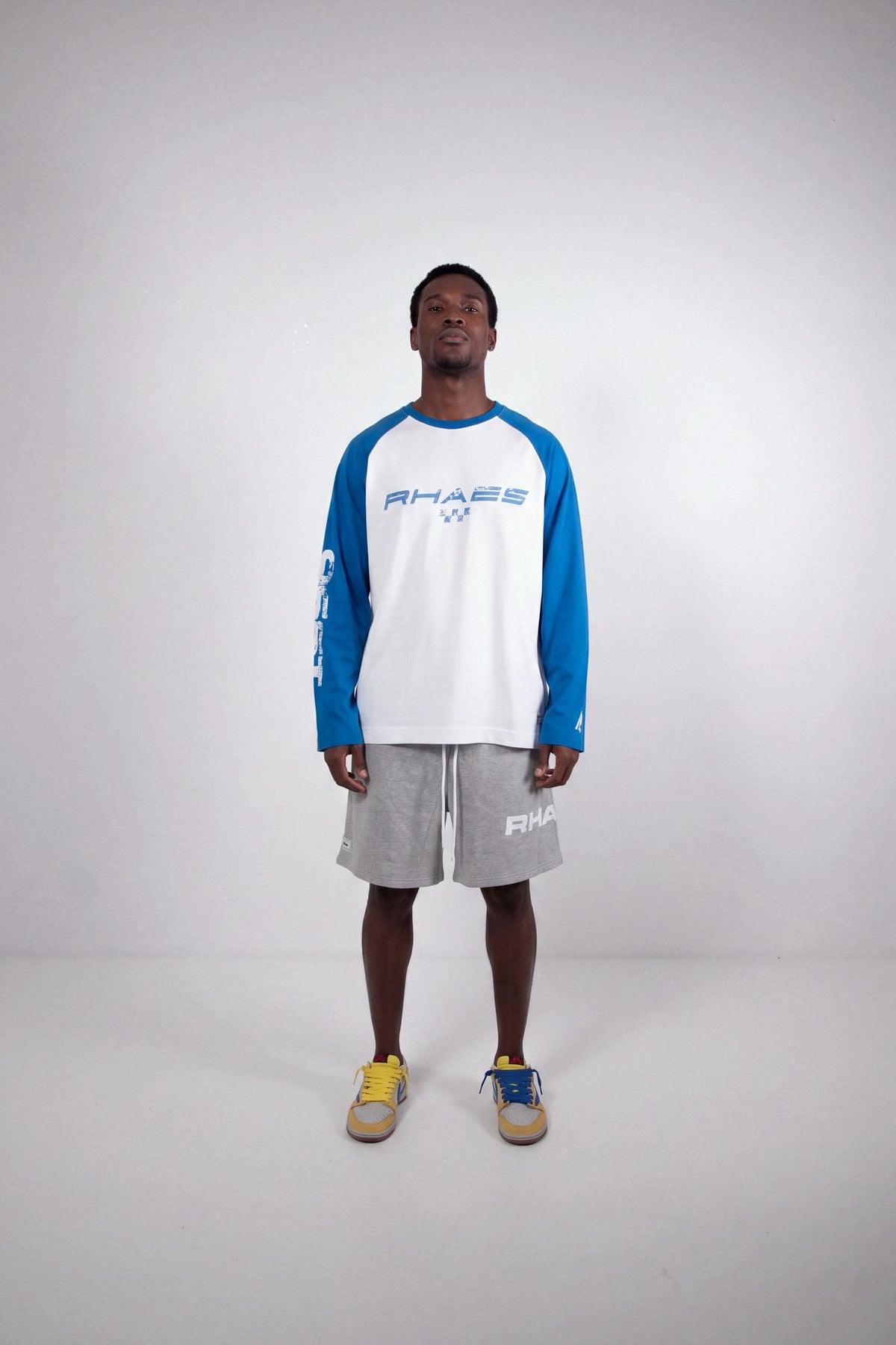 Model wearing RHAES 1995 Raglan Long Sleeve with RHAES Essential Shorts — full body