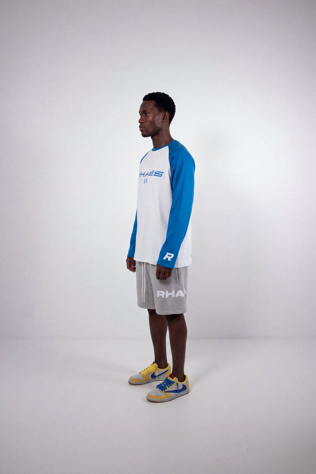Model wearing RHAES 1995 Raglan Long Sleeve — full body side profile