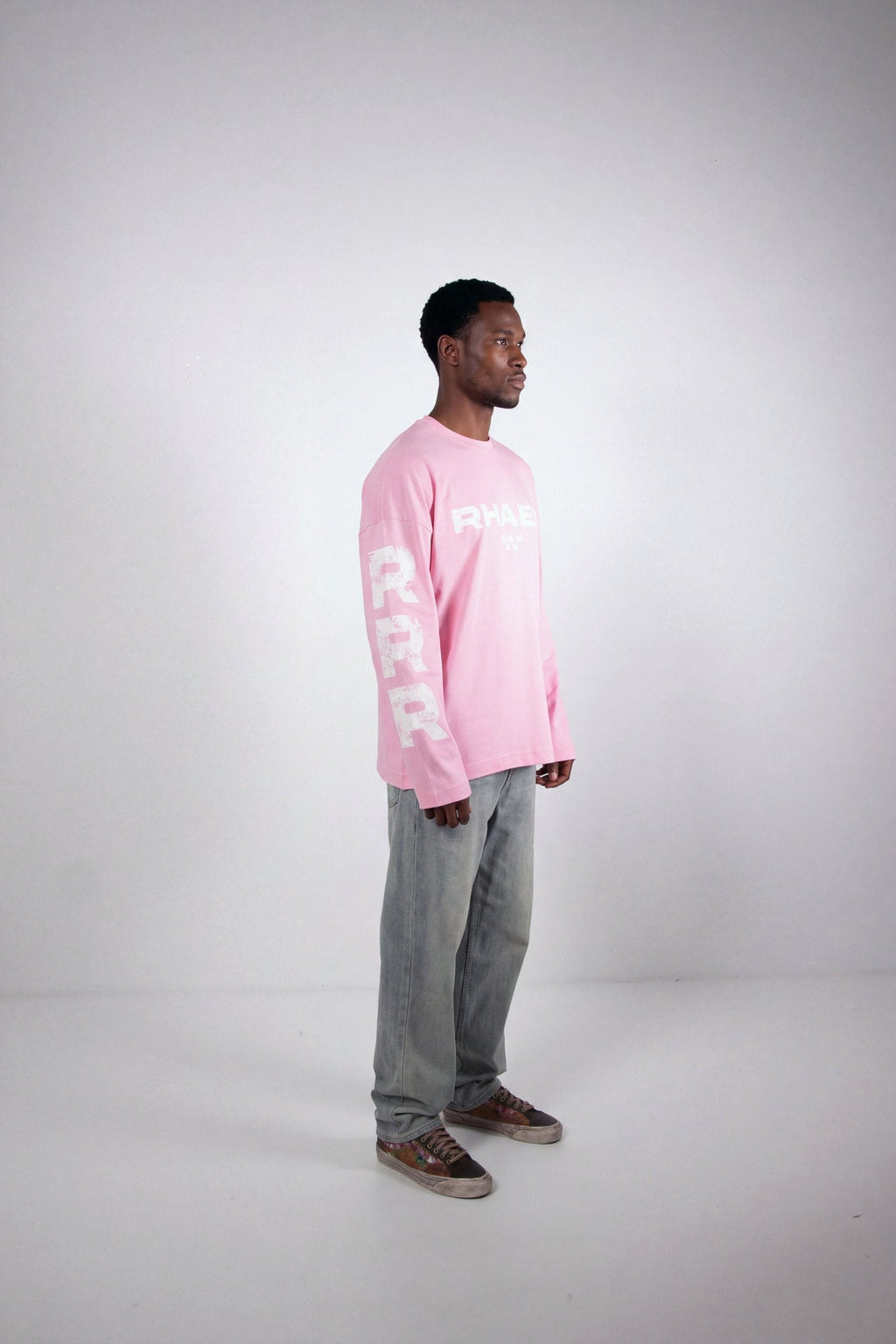 Model wearing RHAES 22 Long Sleeve in Soft Pink — full body side profile