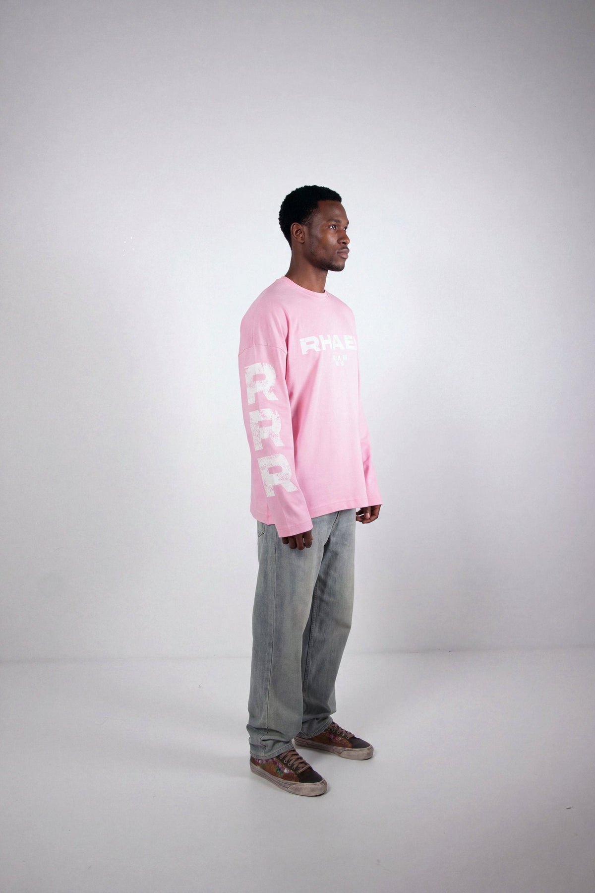 Model wearing RHAES 22 Long Sleeve in Soft Pink — full body side profile