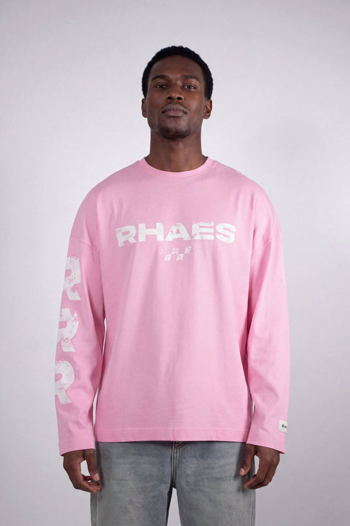 Model wearing RHAES 22 Long Sleeve in Soft Pink — distressed RHAES chest print