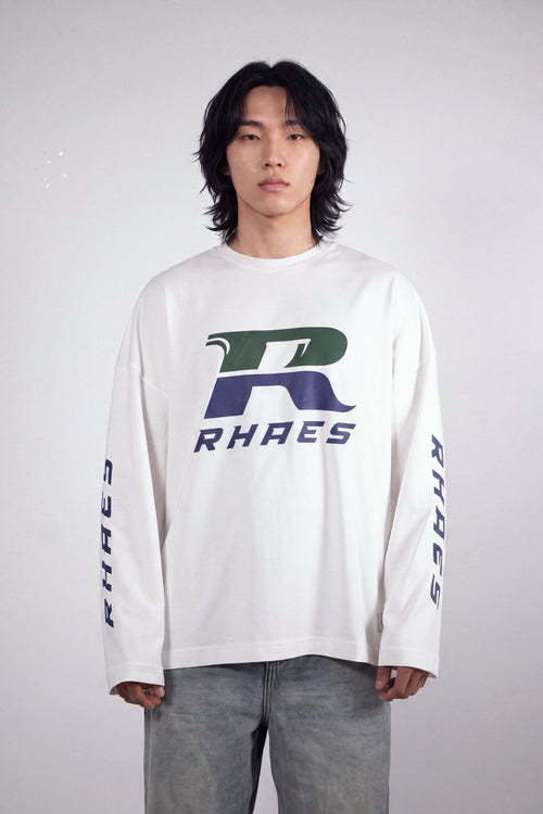 Model wearing RHAES Racing Long Sleeve in White — racing R chest print, front view