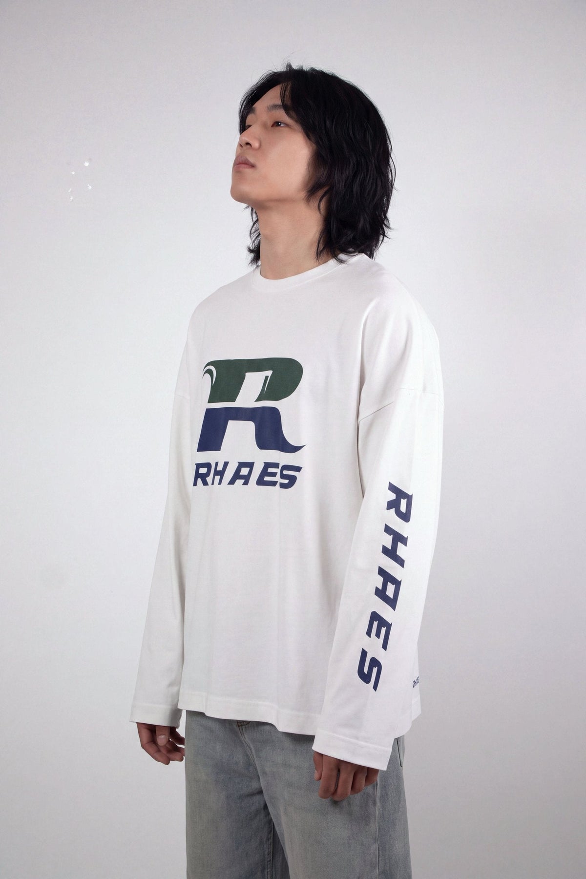 RHAES Racing Long Sleeve in White — three-quarter view with sleeve lettering